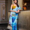 Model wearing a glossy printed satin saree with an unstitched hotfix Moonga blouse, styled for a festive occasion.