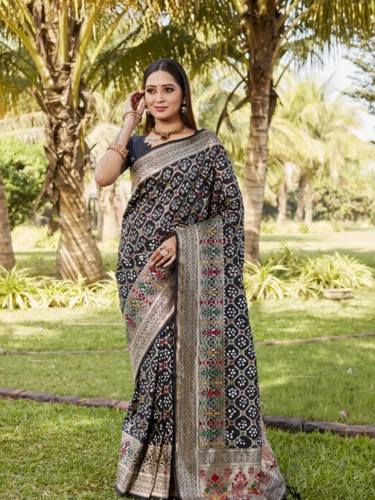 Woman wearing a Gharchola Bandhej silk saree with Paithani pallu and zari border
