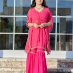 Model wearing Golden Zari Work Kurti-Sharara Set in festive backdrop