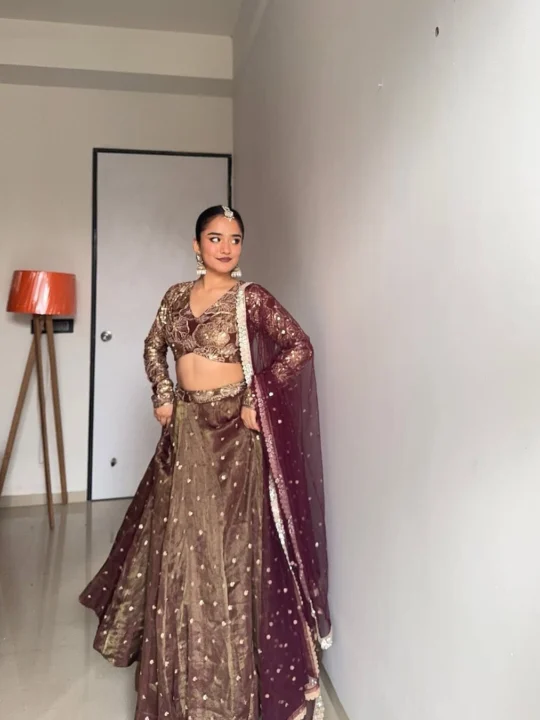 Front view of model wearing handwoven golden zari work lehenga choli with dupatta.
