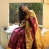 Model wearing a Banarasi Lichi Silk Saree with golden zari, styled for a wedding occasion.