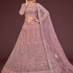 Pearl pink net lehenga choli with zari and thread embroidery by Pramukhmart