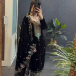 Woman wearing embroidered velvet winter wedding suit set with cutwork dupatta