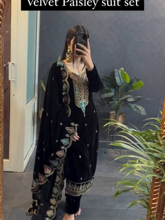 Woman wearing embroidered velvet winter wedding suit set with cutwork dupatta