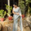 Woman wearing elegant georgette sequin saree with embroidery and lace border